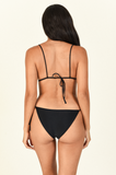 Model standing to the back wearing the Via Top and Ties Bottom in Black