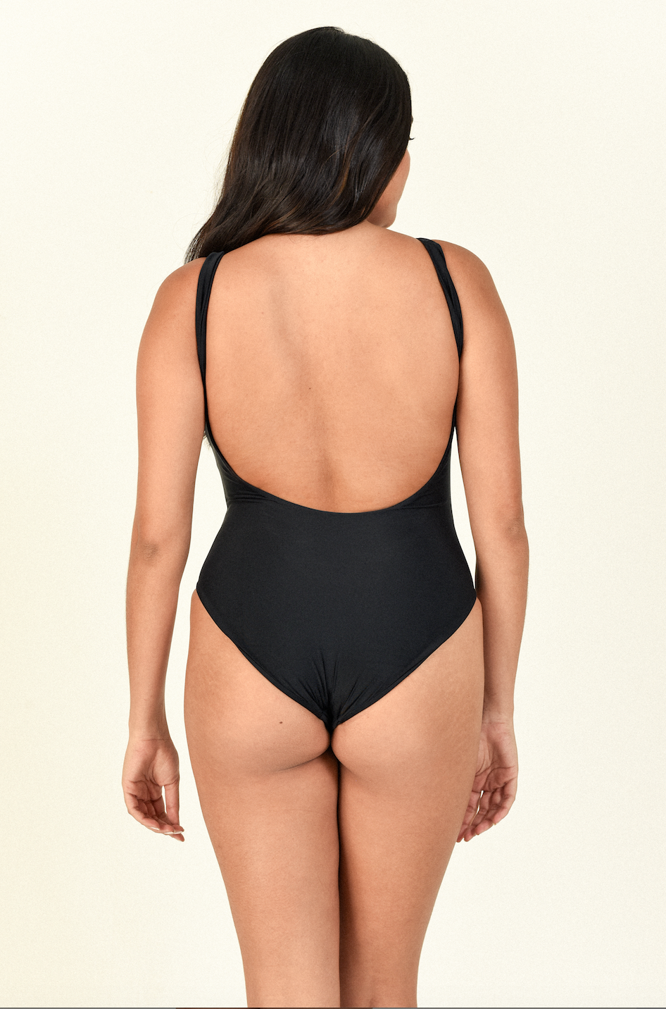 Model standing backwards showing the back of the Contour One Piece in Black