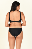 Model standing to the back to the side wearing the Rounded Edges Top and Most Wanted Bottom in Black