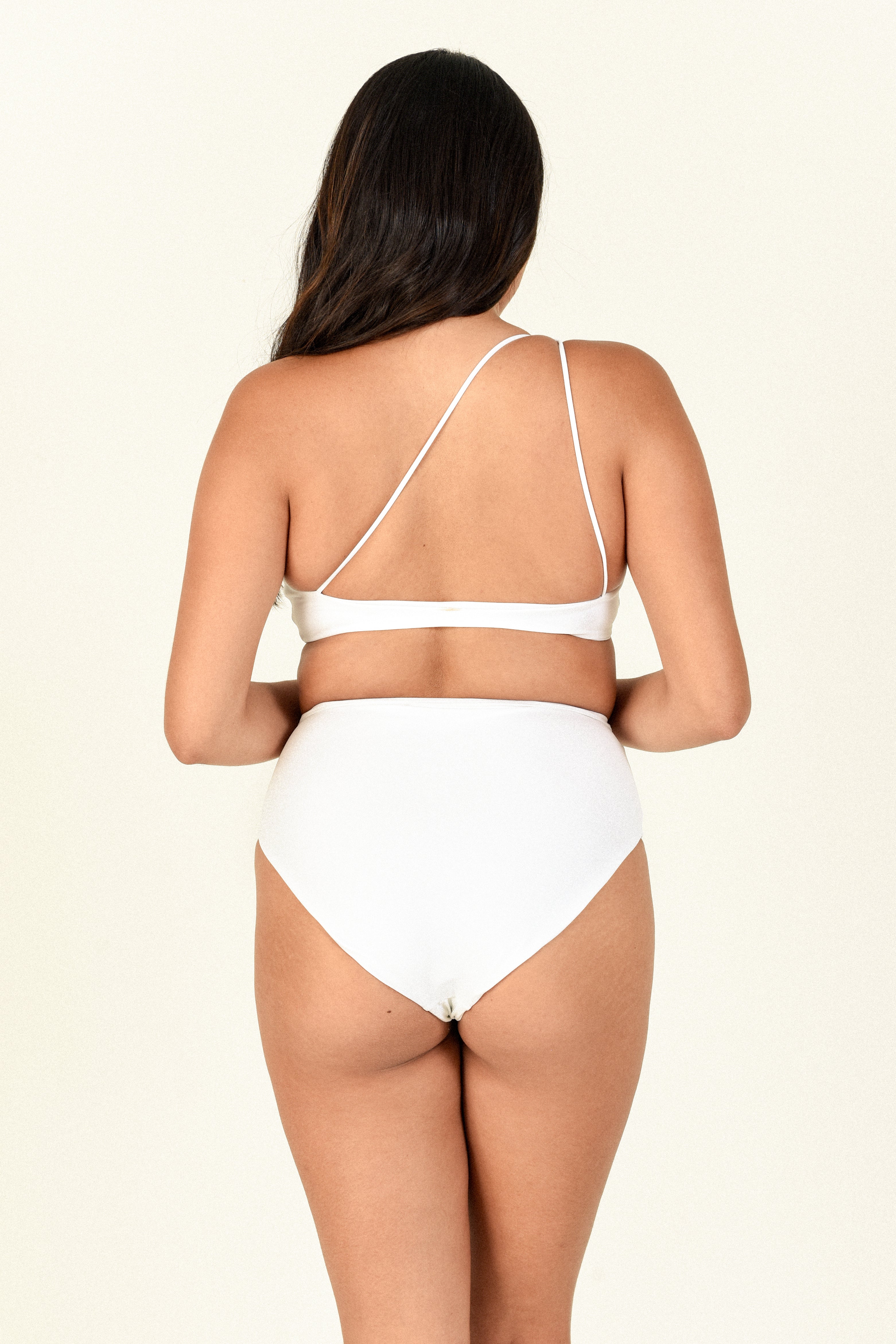 Model against white background showing the back of Apex Top and Bound Bottom in White