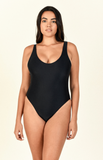 Model standing against white background wearing the Contour One Piece in black