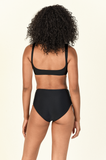 Model standing to show the back of the Rounded Edges Top and Bound Bottom in Black