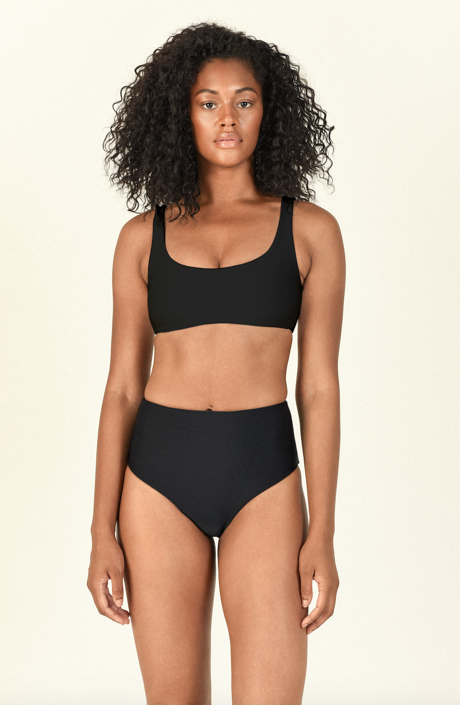 Model standing wearing the Rounded Edges Top and Bound Bottom in Black