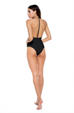 Model standing in front of a white background showing the back of the All in One Piece in Black