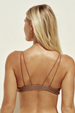 Model standing to show the back of the Micro Kora Top in Nude